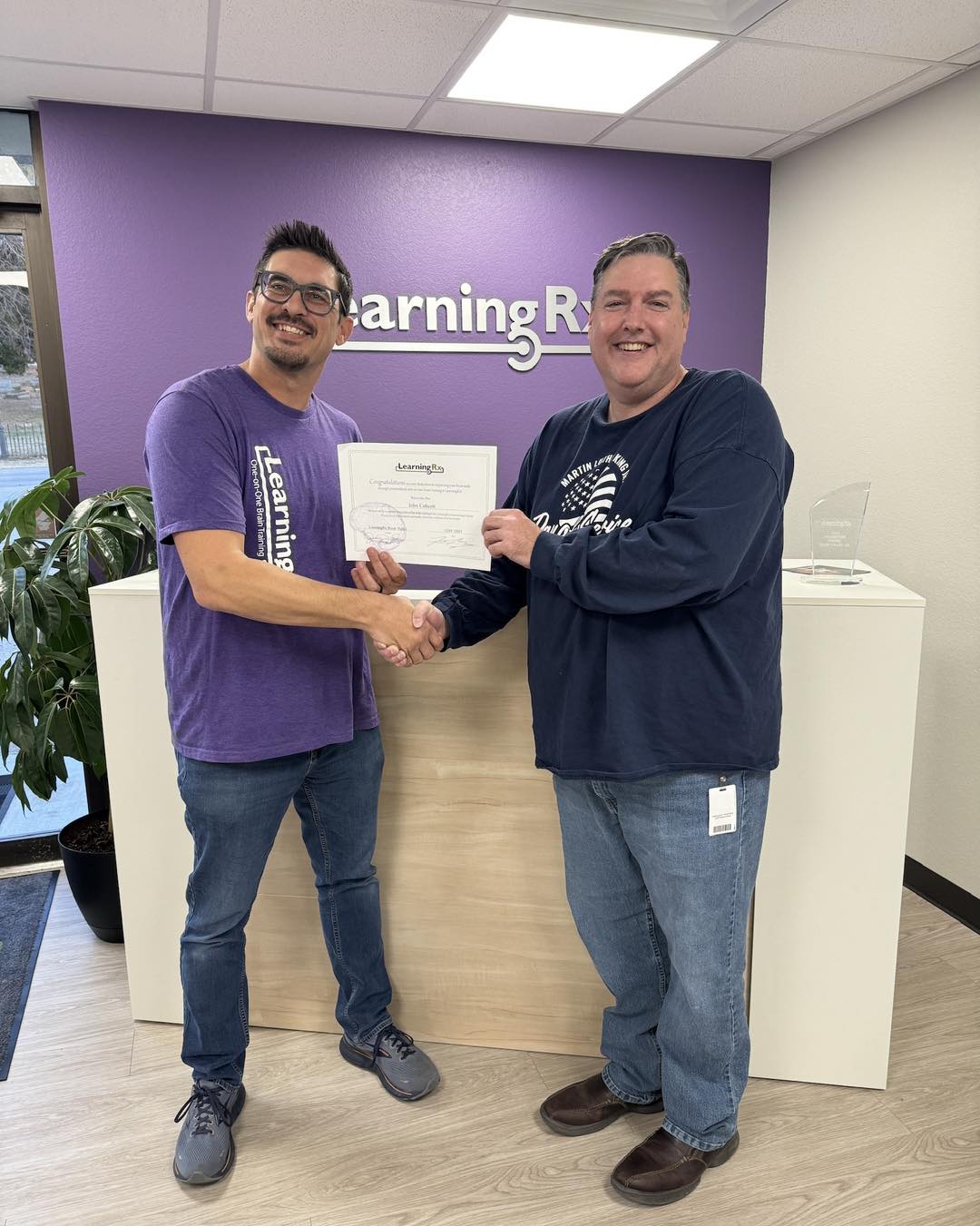 Adult getting certificate for graduating reading program at LearningRx.
