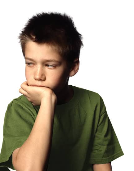Boy sitting in a defiant pose