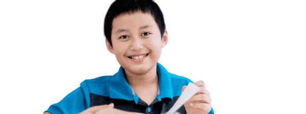 Boy smiles while turning pages in a book