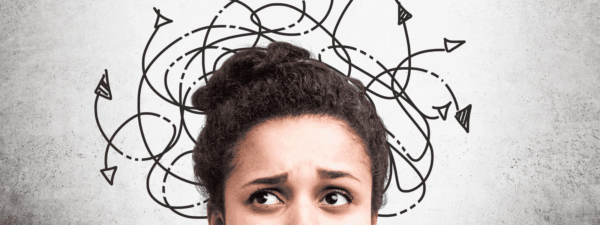 Image of top of woman's head. She is visibly concerned with drawn, confused arrows in the background