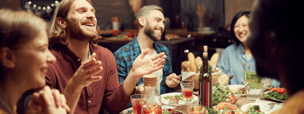 Family sitting around a table laughing together