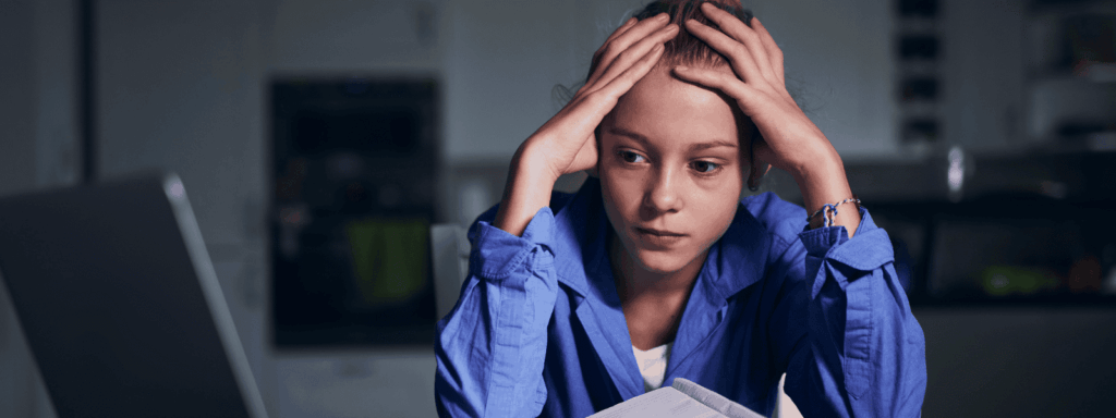 Girl holding head, frustrated by school work