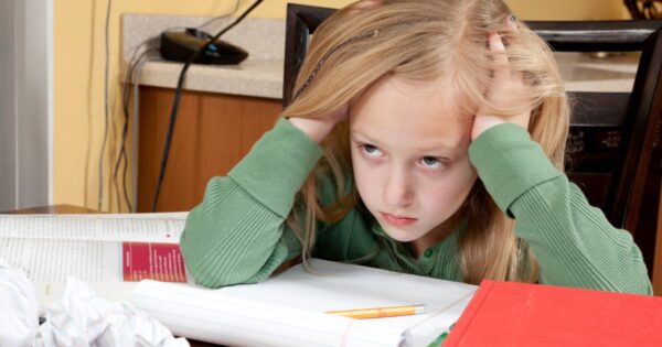 Girl who is clearly frustrated with schoolwork