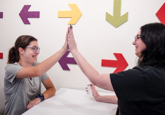 Brain trainer and student high five during their session at LearningRx