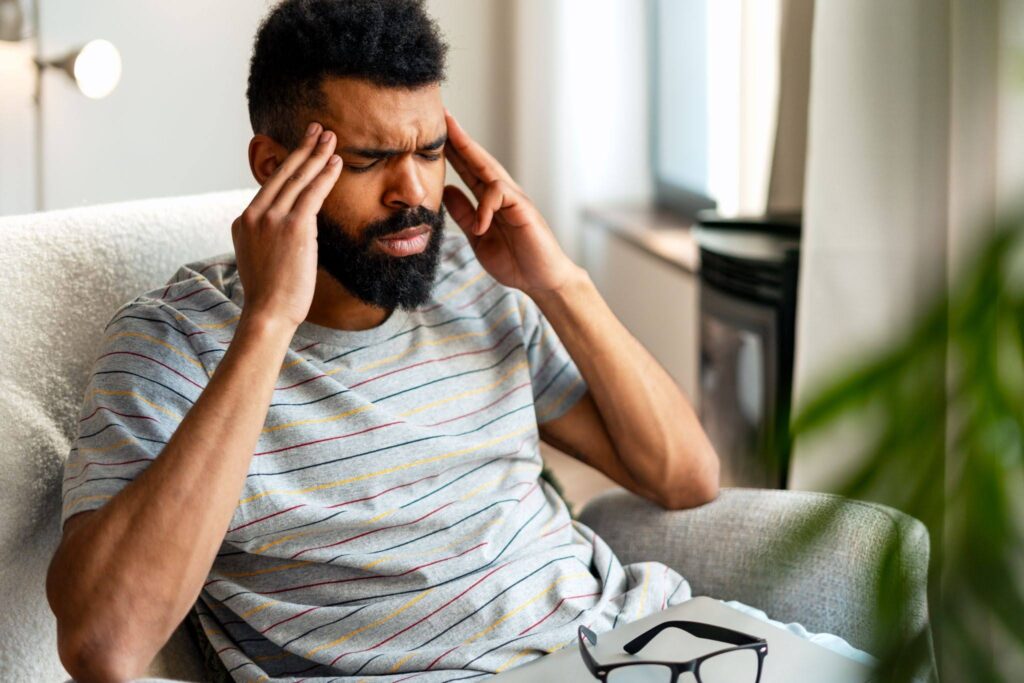 Adult experiencing brain fog and mental fatigue at work after a concussion