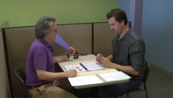 Former athlete working one-on-one with a brain trainer on cognitive skills exercises