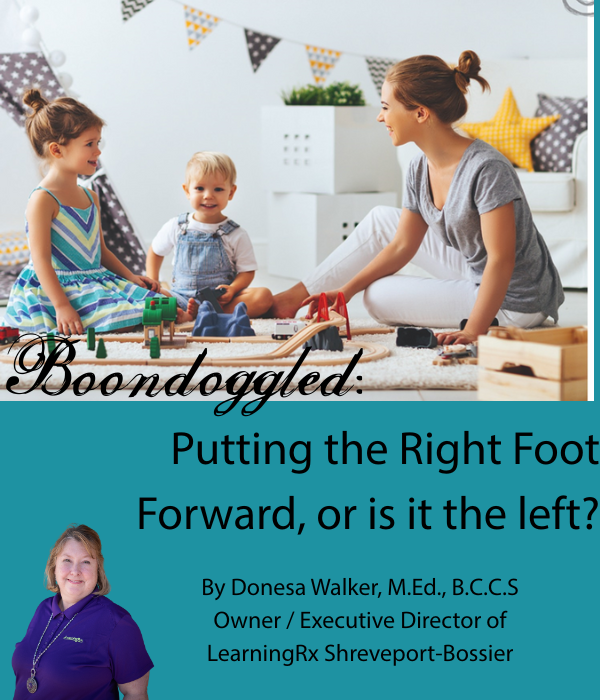 A mom playing with her two kids and a train set. They are very happy. The image includes the title of the blog. Boondoggled: Putting the right foot forward, or is it the left?