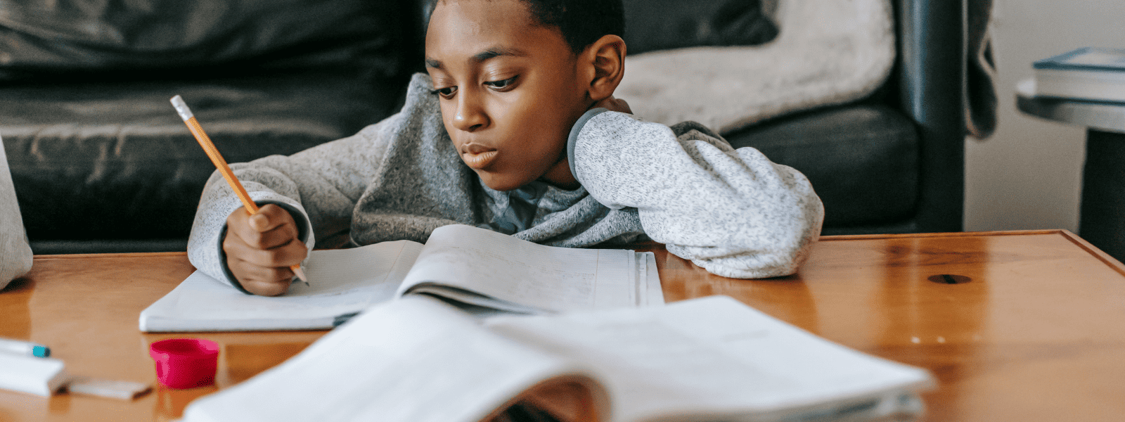 Student writing on a copy with pencil with tutoring services in Atlanta