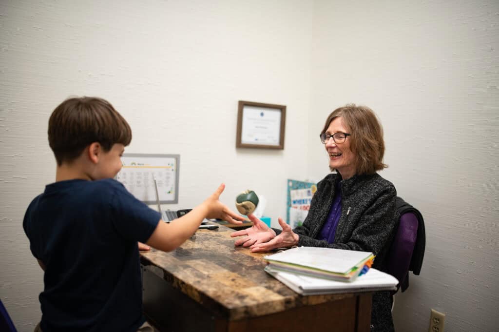 Trainer Joan working on integrative bag with her student. 