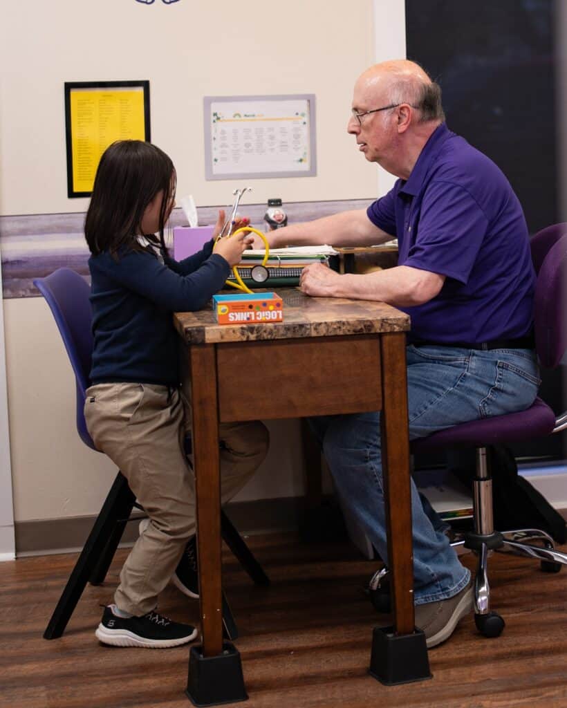 February newsletter - Trainer Phil playing a cognitive game with his student.